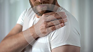 Male suffering from shoulder ache, muscle pain, inflammation sprain problem