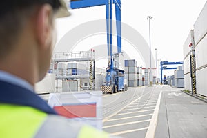 Male supervisor with clipboard in shipping yard