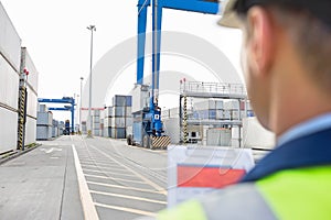Male supervisor with clipboard in shipping yard
