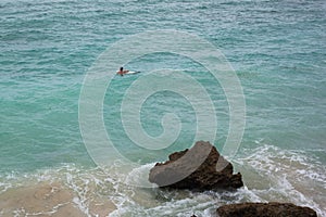 Male surfer alone on azure waves of Indian ocean