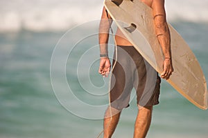 Male Surfer Stands Beach Watching Surf Waiting Surfboard