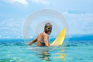 Male surfer waiting for the wave