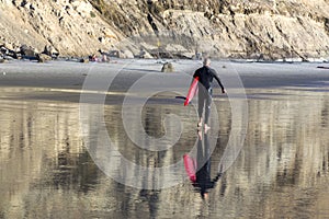 Male Surfer with Red Surf Board on Torrey Pines Beach in San Diego California