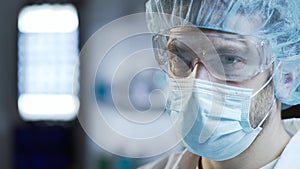 Male surgeon preparing for complex operation, medicine of future, closeup