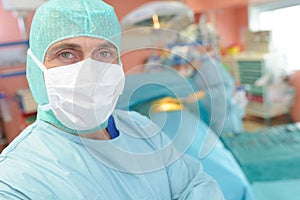 Male surgeon preparing for operation in operation room