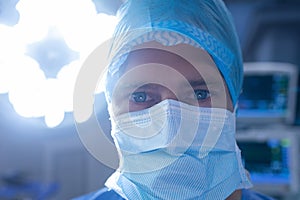 Male surgeon standing in operation theater at hospital