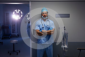 Male surgeon standing outside the operation room at hospital