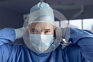 Male surgeon wearing surgical mask in operation room at hospital