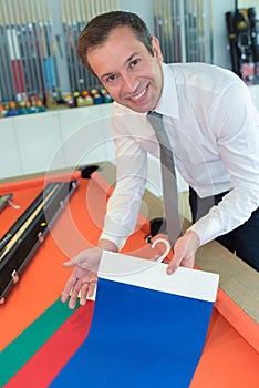 male tailor choosing fabric