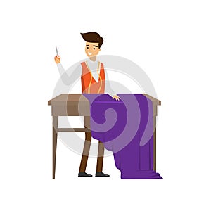 Male tailor standing at table with scissors in hand ready cut purple cloth