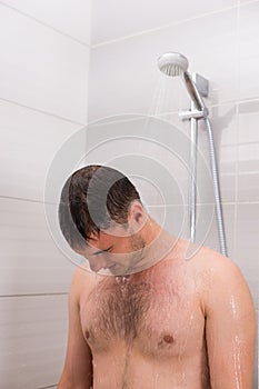 Male taking a shower in the bathroom