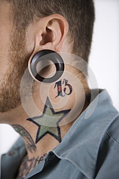 Male with tattoos and piercing