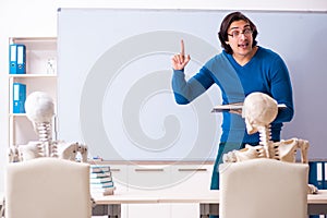 The male teacher and skeleton student in the classroom