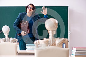 Male teacher and skeleton student in the classroom