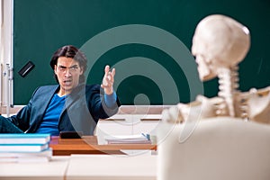 Male teacher and skeleton student in the classroom