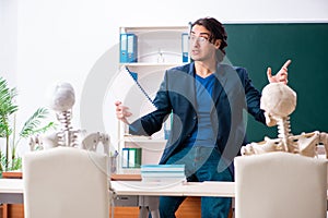 Male teacher and skeleton student in the classroom