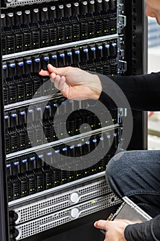 Male Technical Consultant Checking SAN array in Datacenter