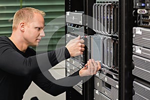 Male Technical Consultant Replacing Blade Server In SAN At Datacenter