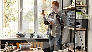 Male IT technician or engineer look at microchip