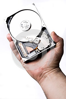 Male technician hand holding computer hard drive over white back