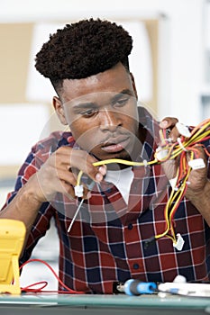 male technician inspecting computer wiring system