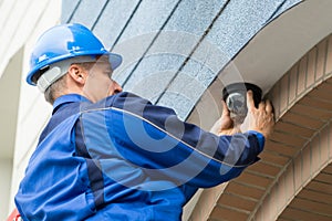 Male Technician Installing Camera