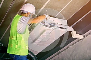 Male Technician Repairing Air Conditioner