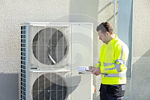 Male Technician Repairing Air Conditioner Outdoors