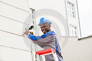 Male Technician Repairing Camera