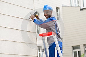 Male Technician Repairing Camera