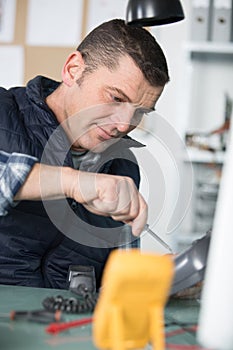 male technician repairing landline telephone