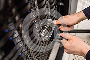 Male Technician Replacing Server Drive At Datacenter