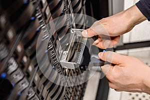 Male Technician Replacing Server Drive At Datacenter