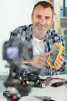 male technician using camera to make tutorial