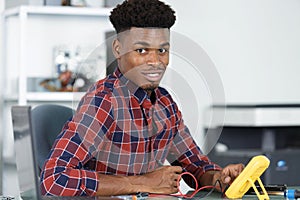 Male technician using voltage meter