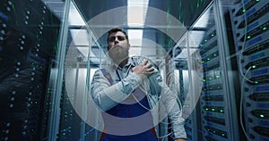 Male technician working in a data center