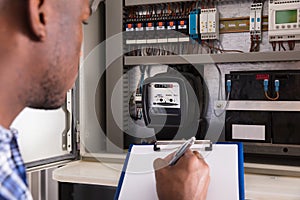 Male Technician Writing On Clipboard
