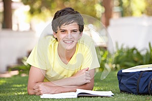 Male Teenage Student Studying In Park