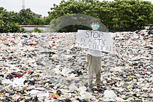 Male teenager holds stop plastic pollution text