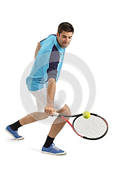 Male tennis player hitting the ball