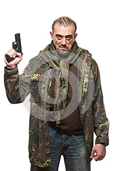 Male terrorist in a military jacket with a gun in