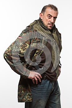 Male terrorist. military jacket. gun in his hand.
