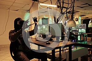 Male thief programming computer virus in vr headset