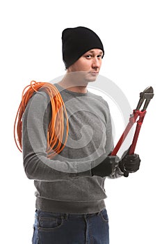 Male thief with rolled cable and wire stripper on white background
