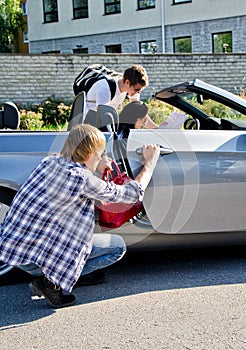 Male thief stealing handbag from the car photo