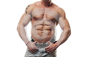 Male torso in blue jeans. Portrait of strong healthy power fitness handsome athletic man with muscular trained body