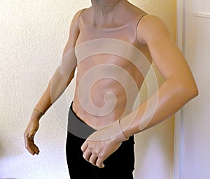 Male torso, mannequin, half naked headless, wearing a black trousers