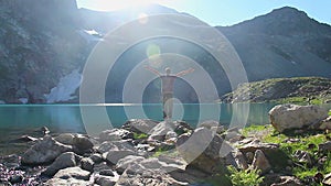 Male tourist enjoying freedom beautiful view near mountain lake