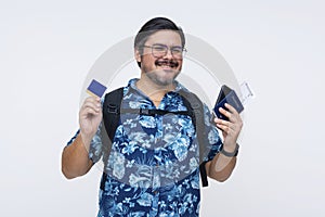 A male tourist in a Hawaiian shirt showing his Frequent Traveller Credit Card while receiving his boarding pass and US passport.