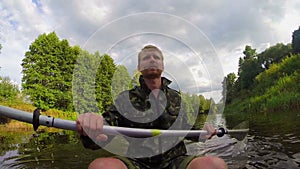 Male tourist kayaking on river, action camera, vacation, slow-mo